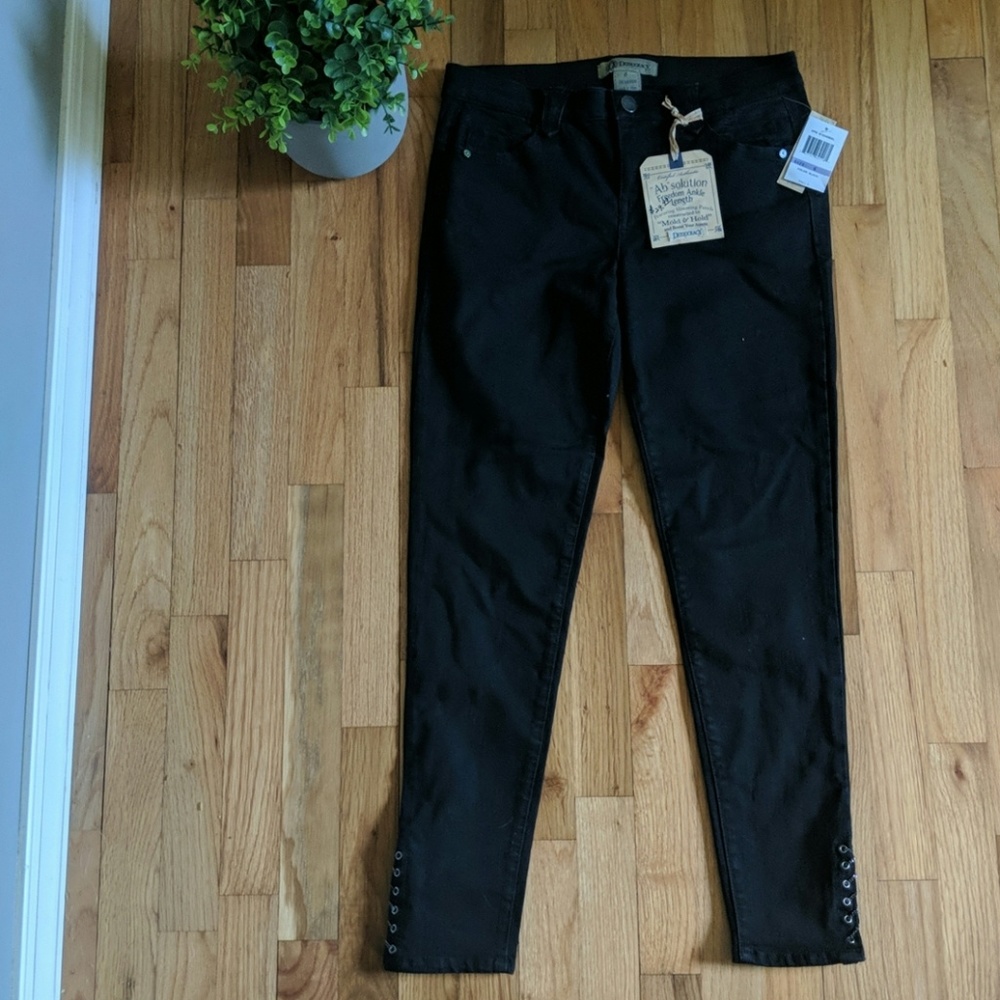 Black jeans with chain detailing on ankle.